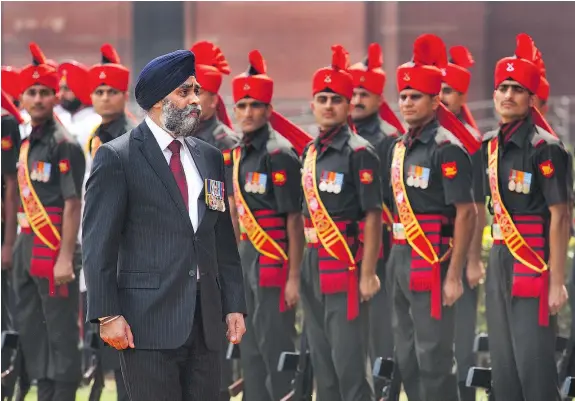  ??  ?? Canadian Defence Minister Harjit Sajjan, inspecting a tri-services guard of honour April 18 in New Delhi, will return to the House of Commons in Ottawa Monday for the first time since being accused of a ‘bald-faced lie’ on his role in the Afghanista­n mission.