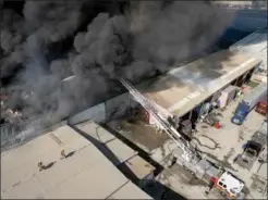  ?? GUILLERMO ARIAS / AFP ?? Smoke clouds are seen after seven factories and warehouses caught fire at an industrial cluster near the US-Mexico border in Tijuana, Baja California state, Mexico, on Jan 28.