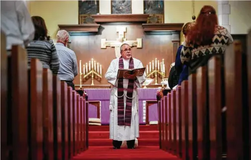  ?? Jon Shapley photos / Houston Chronicle ?? Keith Giblin, a magistrate judge and Episcopal priest, reads a passage from the Bible during a service at St. Paul’s Episcopal Church in Orange.