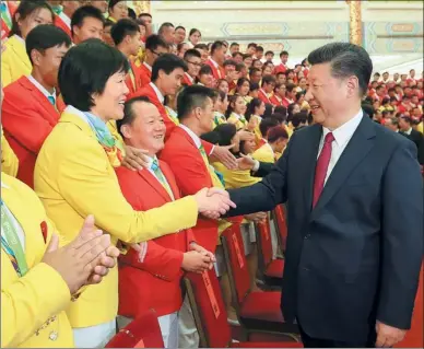  ?? LAN HONGGUANG / XINHUA ?? President Xi Jinping greets Lang Ping, head coach of the Chinese women’s volleyball team, at a meeting attended by the Chinese Olympic delegation and the Standing Committee of the Political Bureau of the Communist Party of China Central Committee.