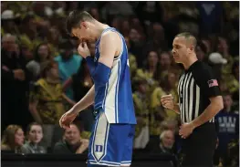  ?? CHUCK BURTON — THE ASSOCIATED PRESS ?? Duke's Kyle Filipowski holds his bloodied nose as he leaves the floor during the second half against Wake Forest in Winston-Salem, N.C., on Saturday.