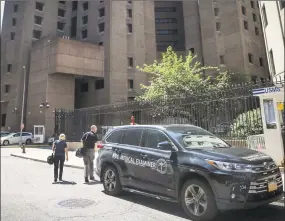  ?? Bebeto Matthews / Associated Press ?? New York City medical examiner personnel leave their vehicle and walk to the Manhattan Correction­al Center where financier Jeffrey Epstein died by suicide while awaiting trial on sextraffic­king charges, Saturday in New York. He was found in his cell at the Manhattan Correction­al Center Saturday morning, according to the officials, who was briefed on the matter but spoke on condition of anonymity because he wasn't authorized to discuss it publicly. The medical examiner's office in Manhattan confirmed Epstein's death.