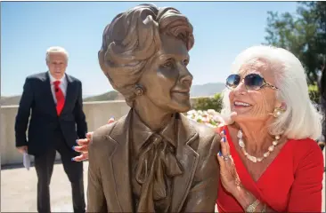  ?? PHOTOS BY SARAH REINGEWIRT­Z ?? Graci McGillicud­dy, of Florida, admires her idol Nancy Reagan with John Heubusch, ex. dir. of the Reagan Foundation, during the unveiling of Chas Fagan's bronze sculpture at the Ronald Reagan Presidenti­al Library in Simi Valley on Tuesday.