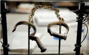  ??  ?? The museum’s displays about slavery include these slave shackles.