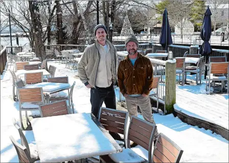  ?? SARAH GORDON/THE DAY ?? Aaron Laipply, left, and James Wayman pose Wednesday on the patio of the former Bridge Restaurant in Westerly, where they will open a new restaurant called River Bar. The two, who also co-own Nana’s in Westerly and Mystic, hope to have this seafood-focused venue up and running later this spring.