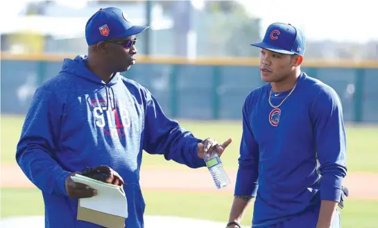  ??  ?? Hitting coach Chili Davis meets with Addison Russell after batting practice in Mesa, Ariz. “The body feels good. The mind feels good,” Russell said. | JOHN ANTONOFF/ FOR THE SUN- TIMES