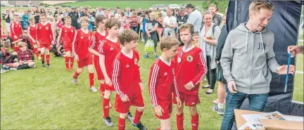  ??  ?? Raymond’s work is not all scenic. Here medals are presented at a youth football festival last June.