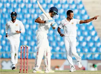  ??  ?? Lanka’s Vishwa Fernando celebrates after taking the wicket of Ravichandr­an Ashwin during a Test match between Sri Lanka and India in Pallekele,
Sri Lanka, on Saturday. (Reuters)