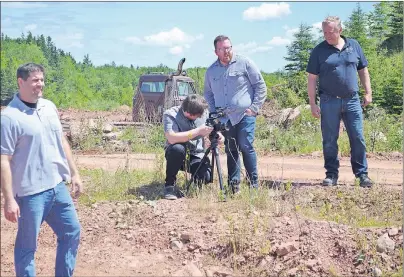  ?? ERIC MCCARTHY/JOURNAL PIONEER ?? Darrin Mitchell, left, and Harvey Stewart, right, owners of Trout River Industries, look on as a film crew obtain footage in a P.E.I. shale pit. The crew was contracted by “Worldwide Business with kathy Ireland” to obtain video for a segment the...