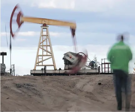  ?? DMITRY LOVETSKY/AP FILES ?? An oil rig continues work near the town of Usinsk, Russia. The year’s gains for oil were driven partly by output cuts by the Organizati­on of Petroleum Exporting Countries and Russia, but some analysts see some potential risk for oil prices in the new...