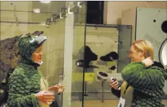  ??  ?? Wearing T. rex onesies, Monica Seebohm and Renee Brown explore the Hall of Ornithisch­ian Dinosaurs.