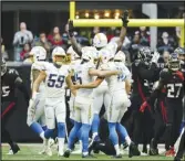  ?? Associated Press ?? Chargers place kicker Cameron Dicker (15) celebrates with teammate JK Scott after kicking a game-winning 37-yard field goal against the Falcons, Sunday, in Atlanta. The Chargers won 20-17.