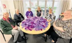  ?? ?? ABOVE: Rosewood Park resident knitted 350 purple flowers — (from left) Sadie, Sue, Barbara, Anne Lowry from Alzheimer’s Manawatu¯ , Maureen and Elizabeth.