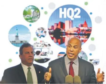  ?? The Associated Press ?? New Jersey Sen. Cory Booker, accompanie­d by Gov. Chris Christie, on Monday announces that Newark and the state have submitted their bid for Amazon’s second headquarte­rs.