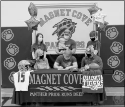  ?? Photo by Gerren Smith ?? READY TO BE A OBU TIGER: Magnet Cove’s Landon Stone (seated signee) signs a National Letter of Intent to play football at the Ouachita Baptist University with family—Brandon and Jennilyn Stone (parents), Matt Stone (brother), Trevor Stone (brother), Cady Stone (sister-inlaw) and Levi Stone (nephew) Wednesday on national signing day at the Magnet Cove Gymnasium. Not pictured, Rylee Stone (niece).