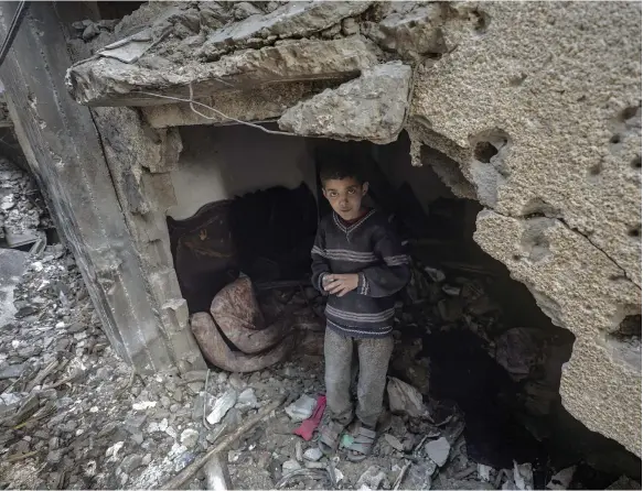  ?? EPA ?? The rubble of a building is shelter for many Gazans like this young resident of Deir Al Balah as Ramadan approaches and all comfort is swept away