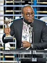  ?? CHRIS PIZZELLO/INVISION ?? Barry Jenkins accepts the best director award for “Moonlight” at Saturday’s Spirit Awards ceremony.