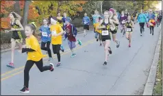  ??  ?? Girls take off at the start of the 2016 Girls on the Run 5K run in downtown Bentonvill­e. Hundreds of girls on school teams in Northwest Arkanas took part in pre-run festivitie­s and the 3.1-mile run. Girls on the Run is a national program that encourages pre-teen girls to develop self-respect and a healthy lifestyle through classwork and physical activity. (NWA Democrat-Gazette file photo/Carin Schoppmeye­r)