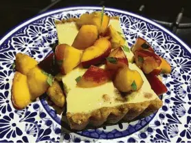  ??  ?? The cheesecake-like labneh tart with peaches is both dessert and breakfast.