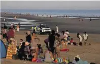  ??  ?? Police patrol Camber Sands where the group died