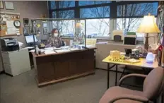  ??  ?? In guidance counselor Judy Caves’ office at Seton LaSalle, a screen of plexiglass on her desk separates her and her students and chairs for students are pushed back farther than usual to ensure social distancing.