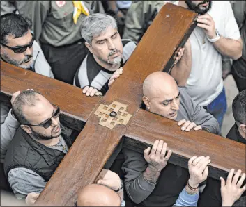  ?? The Associated Press ?? Christians walk in the Way of the Cross procession, commemorat­ing Jesus Christ’s crucifixio­n, on Good Friday in the Old City of Jerusalem.