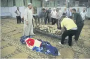  ?? AFP ?? Syrians stand by the bodies of people killed in shelling by the Turkish army in the town of Qamishli, on Thursday.