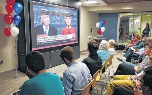  ?? [PHOTO BY NATE BILLINGS, THE OKLAHOMAN] ?? OKLAHOMANS HOLD WATCH PARTY: People watch the first presidenti­al debate between Hillary Clinton and Donald Trump on Monday during a watch party on the lower level of the Bizzell Memorial Library at the University of Oklahoma in Norman.