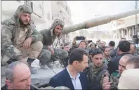  ?? AP PHOTO ?? In this photo released on the official Facebook page of the Syrian Presidency, Syrian President Bashar Assad, centre, speaks with Syrian troops during his visit to the front line in the newly captured areas of eastern Ghouta, near the capital Damascus,...