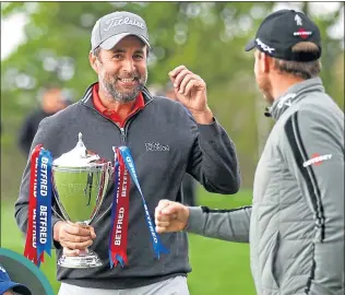  ??  ?? An ecstatic Richard Bland celebrates British Masters success with from US Masters champion Danny Willett