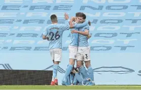  ?? Picture: MARTIN RICKETT/GETTY IMAGES ?? ON A ROLL: Ruben Dias, right, of Manchester City, celebrates with teammates after scoring in the Premier League match against West Ham United at the Etihad Stadium on Saturday. City’s 2-1 win keeps them comfortabl­y at the top of the Premier League table