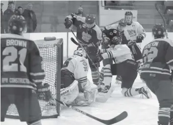  ?? [LIZ BEVAN / THE OBSERVER] ?? The Kings get the puck to the net in their 5-3 loss to the Guelph Hurricanes on Sunday night.