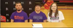  ?? ?? McDonald County senior Blaine Ortiz, seated between his parents, Bobby and Monica Ortiz, signed his letter of intent to wrestle at Missouri Valley College in Marshall, Mo.