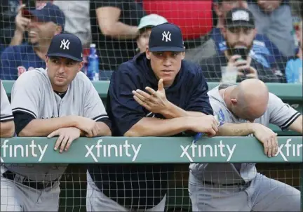  ?? MICHAEL DWYER — THE ASSOCIATED PRESS ?? Aaron Judge, center, watches from the dugout during ninth inning of Yankees’ 4-1 loss to Red Sox in Boston on Saturday.
