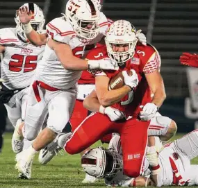  ?? Christian Abraham/Hearst Connecticu­t Media ?? Greenwich’s Jack Konigsberg (5) is taken down during the CIAC Class LL championsh­ip against Fairfield Prep at Rentschler Field in East Hartford on Dec. 10. The teams will meet again in Week 1 to start next season.