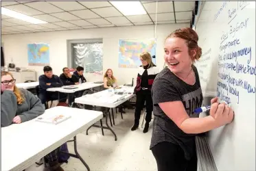  ?? NWA Democrat-Gazette/BEN GOFF • @NWABENGOFF ?? Breanna Brungardt, a junior, takes notes on the white board Wednesday as students in the Marketing and Logistics pathway work on a project in their retail management class at Pea Ridge High School.