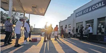  ?? [AP PHOTO] ?? People begin to form a line in the Wednesday morning sun as they wait outside Rose Ice &amp; Coal for it to open days after Hurricane Florence in Wilmington, N.C.