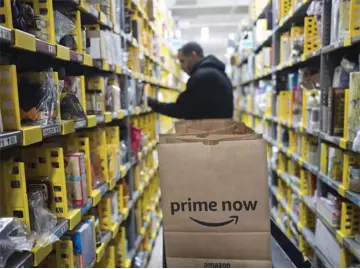  ?? — Amazon photo ?? Amazon raised its starting pay in November, following criticism about its own pay practices and amid concerns among some veteran employees who said they feared being devalued.