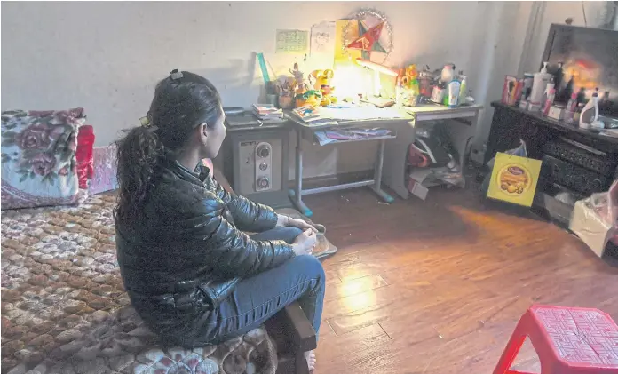  ??  ?? ORDEAL: Nga, mother of an eight-year-old abused girl, sitting in her daughter’s room at her home in Hanoi. The girl is still haunted by the memory of being molested by a family friend.