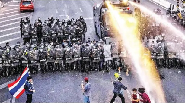  ?? AFP ?? A water-cannon truck is deployed by the police to disperse pro-democracy protesters marching toward the residence of Thai Prime Minister Prayut Chan-o-cha in Bangkok on Sunday.