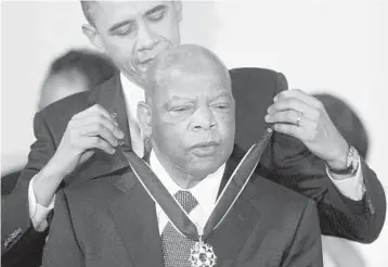  ?? ALEX WONG/GETTY-AFP 2011 ?? Lewis is presented with the Medal of Freedom by President Barack Obama during an event at the White House.