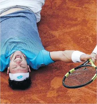  ?? THE ASSOCIATED PRESS ?? Italy’s Marco Cecchinato collapses on the clay after upsetting Serbian Novak Djokovic in their quarterfin­al match on Tuesday at the French Open. The 72nd-ranked Italian won 6-3, 7-6 (4), 1-6, 7-6 (11).