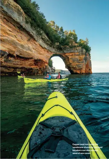  ??  ?? Copper and iron color the sandstone shoreline. Intrepid kayakers can also access several sea caves.