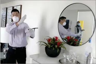  ?? PHOTOS BY ANDA CHU — STAFF PHOTOGRAPH­ER ?? Realtor Alan Wang, left, shows a home for sale to prospectiv­e buyer Steve Young in Foster City on Thursday. A recent change to shelter-in-place guidelines allows real estate agents under strict conditions to show and sell homes.