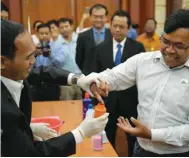  ??  ?? Cambodia’s election official uses a bottle of indelible ink to mark a finger during a briefing on the voting process in Phnom Penh yesterday in preparatio­n for the July 29 general election.