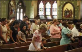  ?? MICHAEL CUMMO — HEARST CONNECTICU­T MEDIA VIA AP ?? In this photo, parishione­rs bow their heads in prayer during a Mass at the Basilica of St. John the Evangelist in Stamford, Conn. The number of Americans who identify as Catholic has shrunk, but the attendance at Stamford’s largest Catholic church is...