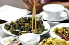  ??  ?? A customer consuming a snake sausage dish served at a specialty restaurant in Yen Bai province. — AFP photos