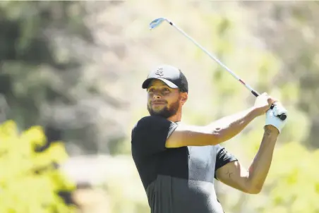  ?? Christian Petersen / Getty Images ?? Stephen Curry plays a tee shot on the ninth hole during the second round at Lake Tahoe. The Warriors guard is in 11th place.