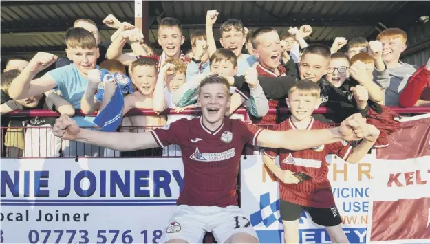  ?? ?? 0 Maksym Kucheriavy­i, whose late goal against Stenhousem­uir wrapped up the League Two title on Saturday, celebrates with Kelty Hearts supporters