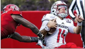  ?? Arkansas Democrat-Gazette/MITCHELL PE MASILUN ?? South Alabama quarterbac­k Evan Orth (right) gets spun around by Arkansas State defensive back Michael Johnson during Saturday’s game at Centennial Bank Stadium in Jonesboro. The Red Wolves won 38-14. For more photos, go to arkansason­line.com/galleries.